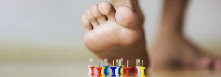 Chiropractic Kalamazoo MI Neuropathy Pain Needles under a foot.